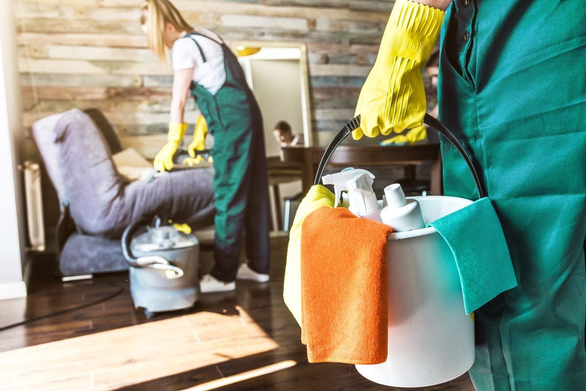 Cleaning service with professional equipment during work. professional kitchenette cleaning, sofa dry cleaning, window and floor washing. man and women in uniform, overalls and rubber gloves